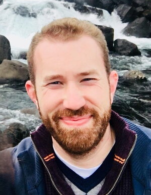 Jordan McAlister in front of a waterfall.