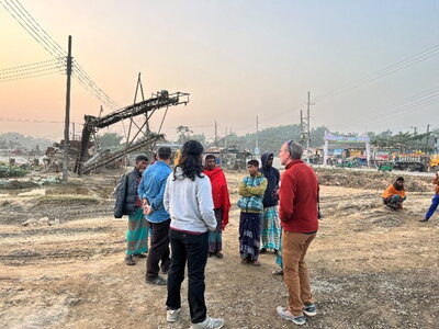 A group of people talking in a mining zone.