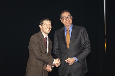 Two men in suits shaking hands.