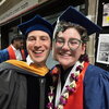 Two people in graduation caps and gowns.