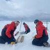 Two researchers taking ice core samples.