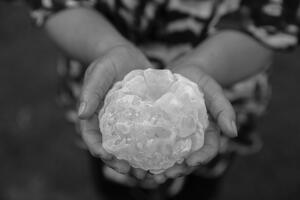 Maria Natividad Garay holds a hailstone she recovered outside her home in Villa Carlos Paz, Argentina. Mitch Dobrowner for The New York Times