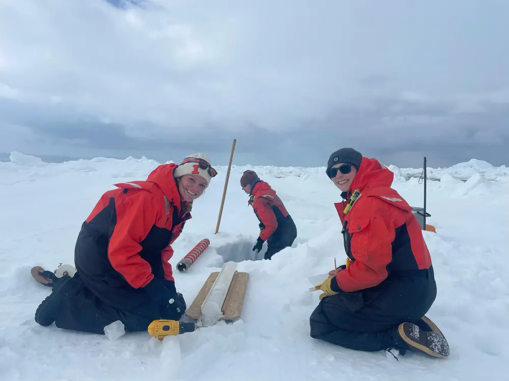 Two researchers taking ice core samples.